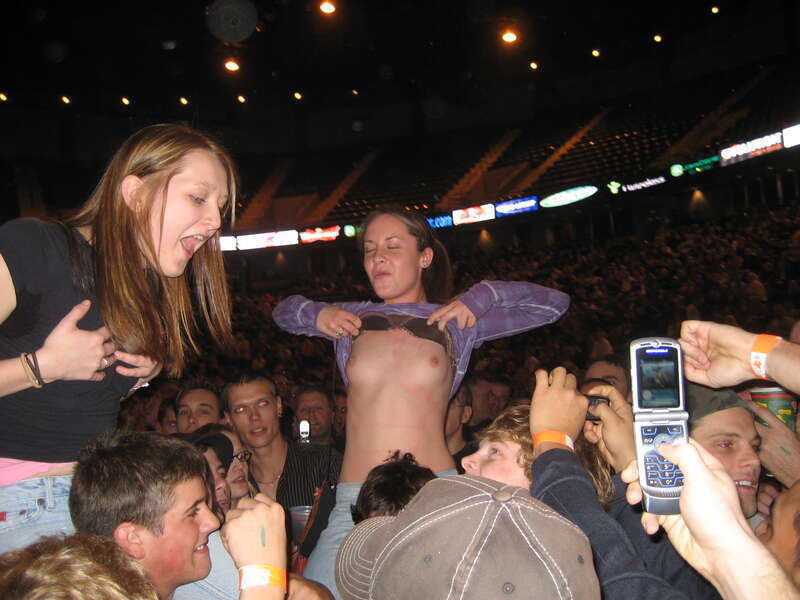 Female fans flashing their breasts at a Godsmack concert in Moline, Illinois on November 5, 2006