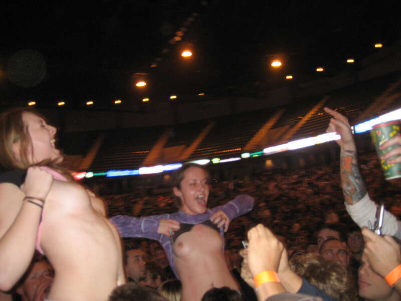 Female fans flashing their breasts at a Godsmack concert in Moline, Illinois on November 5, 2006