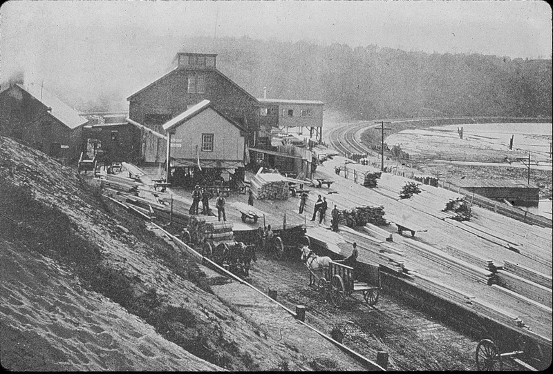 A photograph of the Connecticut River Lumber Company's mills on the banks of Log Pond Cove on the Connecticut River in Holyoke, Massachusetts.