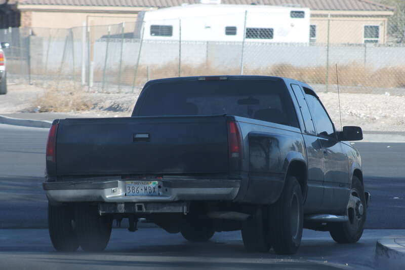 A dark grey 1997 Chevrolet C/K 3500 turning onto North Simmons Street from West San Miguel Avenue, Las Vegas, Nevada.