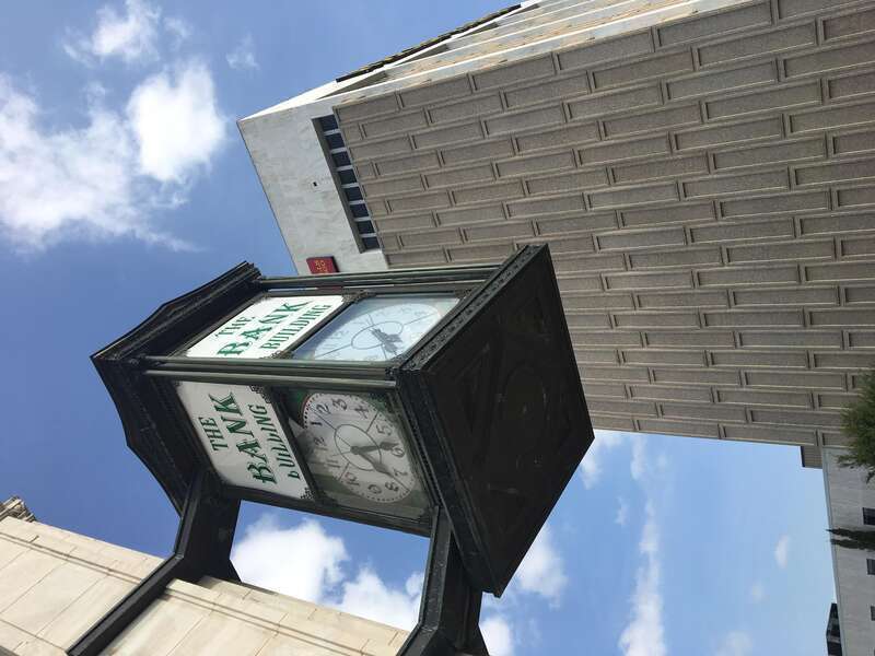 A clock from 1913 features prominently in front of a tower from 1963 in downtown Denton, TX