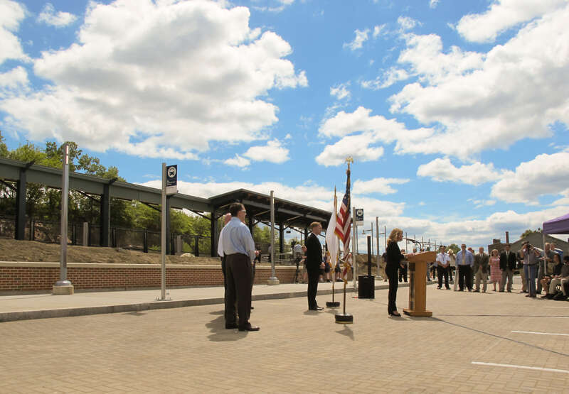 An image of the Depot Square Railroad Station in Holyoke, Massachusetts on opening day.  Lieutenant Governor Karyn Polito is at the podium giving a speech as part of the dedication ceremony. .