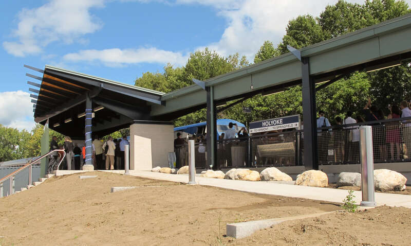 An image of the new Depot Square Railroad Station in Holyoke, Massachusetts on opening day.  The train arriving in the station is the first scheduled Amtrak train, the southbound Vermonter.