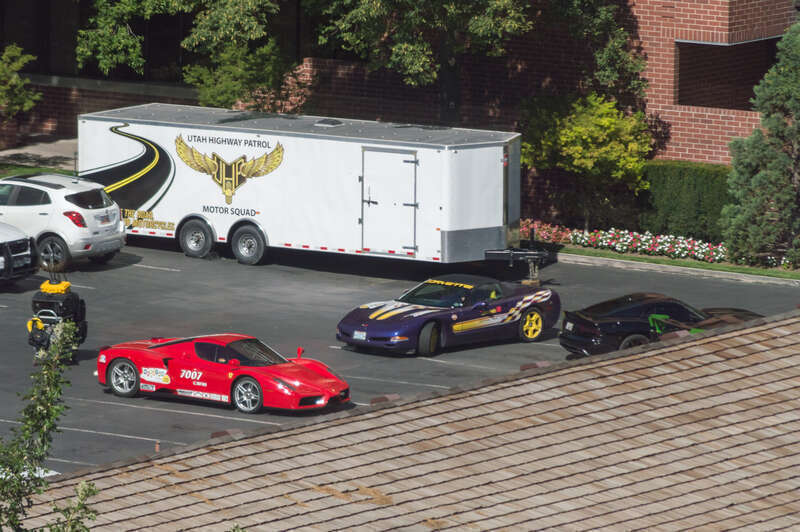 A Ferrari Enzo, a Corvette C5 convertible (official Indianapolis 500 pace car) and an SRT Viper GTS. The cars are participating in the 2015 Beehive Drive and are parked at The Little America Hotel in Salt Lake City. The picture was taken out of the