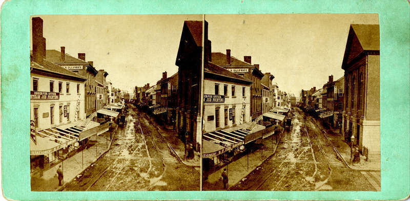 SV-063 — Nelson Dionne Collection. View looking down Essex Street in an easterly direction from Washington Street at Town House Square.

Published by S. Grindal, 144 Essex Street, Salem, Mass., c. 1870.