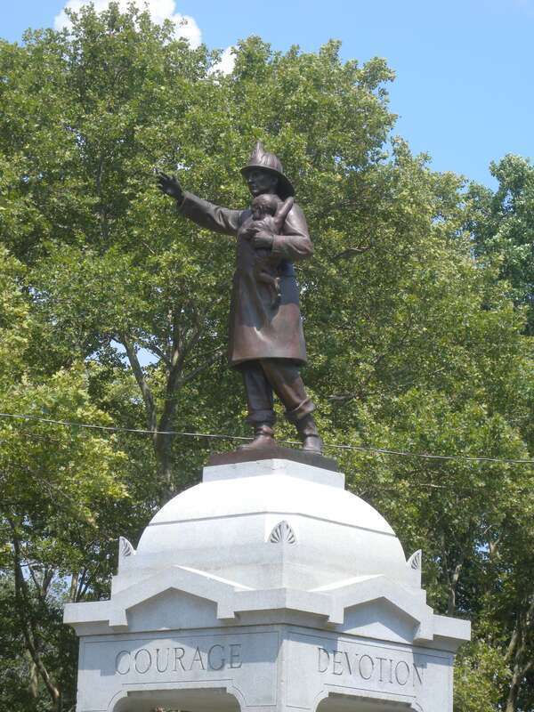 Looking northwest at firemen monument in northeastern Lincoln Park on a sunny midday.