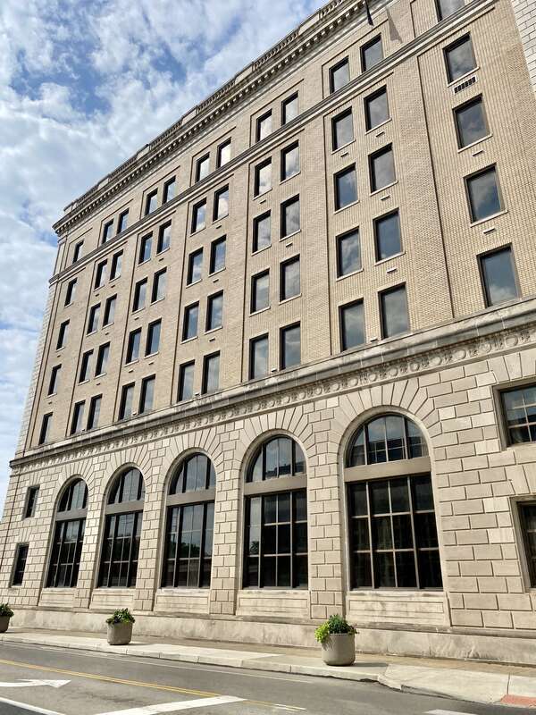 Built in 1921, this Beaux Arts-style building was constructed for the First and Merchants National Bank of Middletown.  The building features a buff brick exterior with a rusticated limestone base, limestone trim, rusticated stone pillars at the
