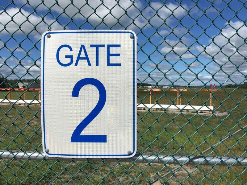 A gate two sign at along the perimeter fence of a small local airport in Nashua, New Hampshire 