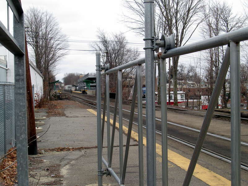 Gates at the former North Leominster station in December 2014. The modern station and garage is visible in the distance.
