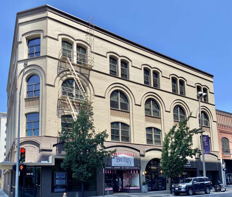 Built in 1890, this Romanesque Revival-style building was designed by Reid Brothers, and was built for Eugene Germond, a prominent early resident of Spokane.  The building features a painted brick exterior with decorative patterned brickwork, arched