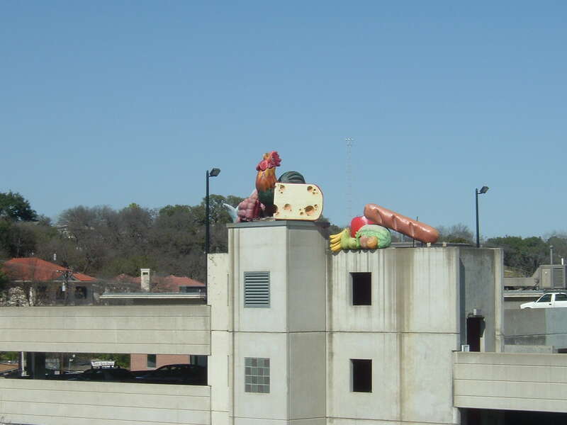 The old Whole Foods parking garage at 5th Street and Lamar in Austin.
I love the huge rooster and food items they have on the garage. I'm glad Book People, or whoever owns it now, decided to leave the stuff there. :)