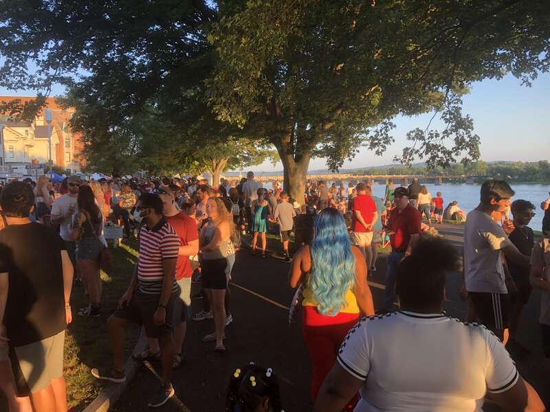 People walking and waiting in line for food trucks on Riverfront Park in Harrisburg, PA, for &quot;July 4th Food Trucks &amp;amp; Fireworks&quot; in 2021