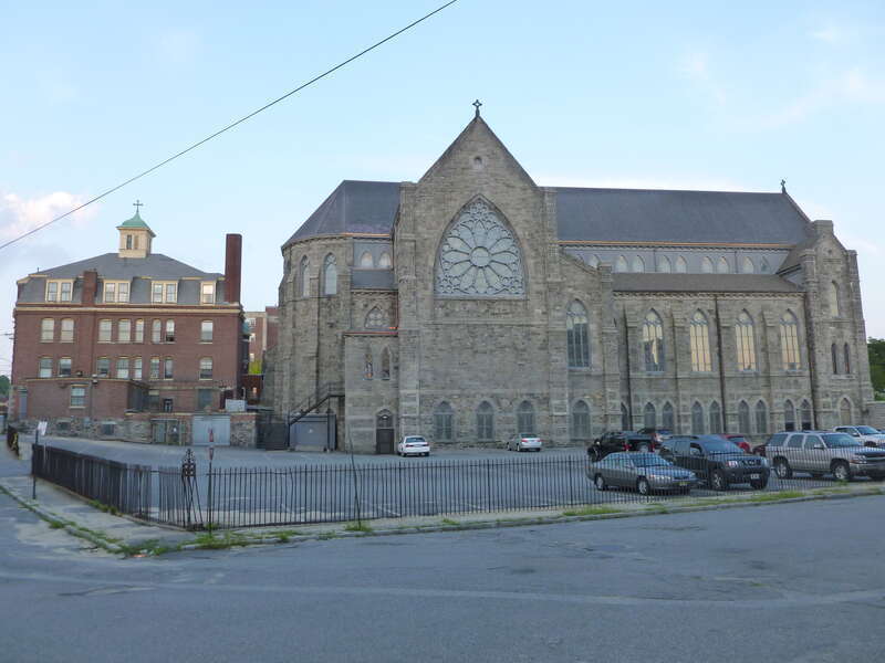 Immaculate Conception Church, a Roman Catholic Church located at 144 East Merrimack Street, Lowell, Massachusetts.  West side of buildings shown.