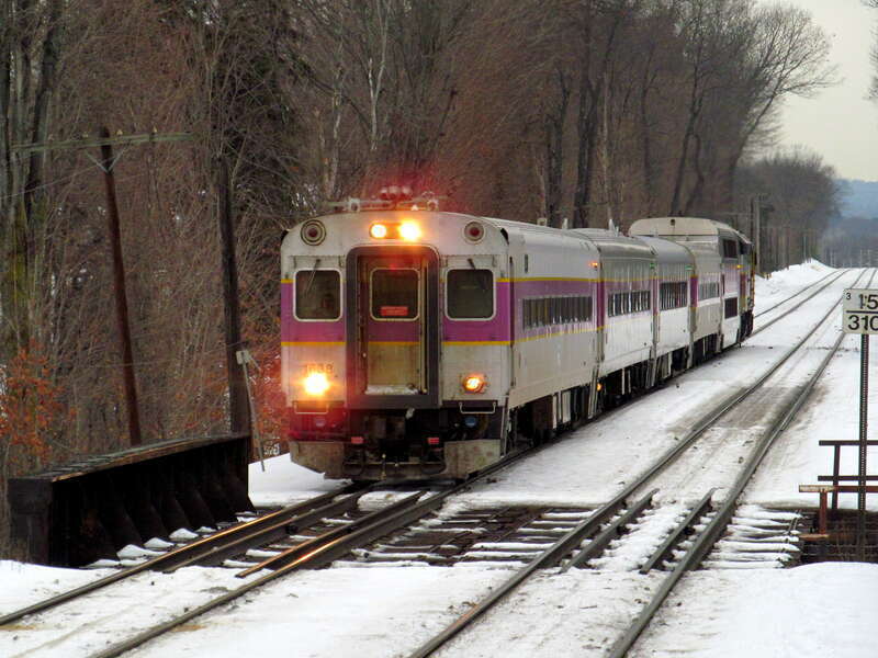 An inbound train passes the snow-covered 1980-built platforms at North Leominster