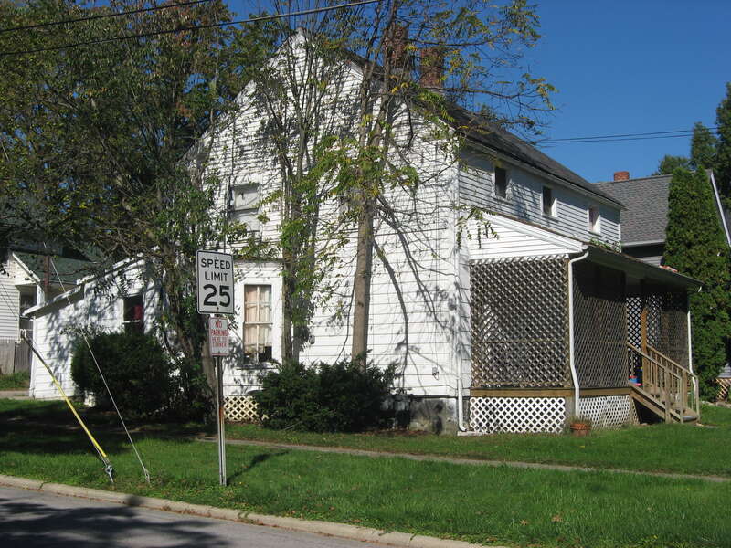 Southern side and front of the John J. Shipherd House, located on the northwestern corner of the junction of Eighth Street and East Avenue in Elyria, Ohio, United States.  Built in 1830, it is listed on the National Register of Historic Places.