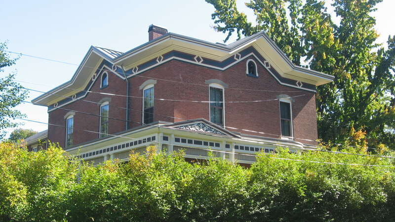 Front and western side of the John Lersch House, located at 121 Harrison Street in Elyria, Ohio, United States.  Built in 1867, it is listed on the National Register of Historic Places, and it is part of a Register-listed historic district, the