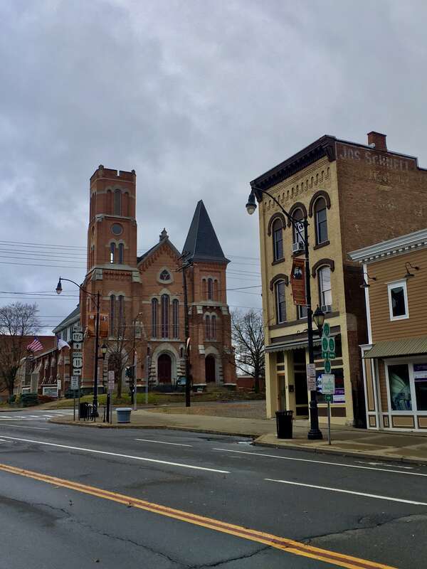 The north side of Main Street at the corner of Front Street in downtown Binghamton, New York, Thanksgiving Day 2019. First Congregational Church is seen at left.