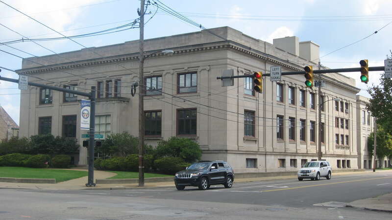 Front and southern side of the Reuben McMillan Free Library, located on the northeastern corner of Rayen (State Route 289) and Wick Avenues in Youngstown, Ohio, United States.  Built in 1909, it is listed on the National Register of Historic Places.