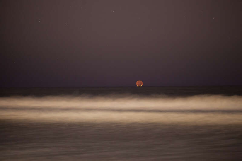 500px provided description: In Redondo Beach, CA. One day old new moon and Mars setting just after sunset. [#Mars ,#Moonset ,#Nigh Sky]