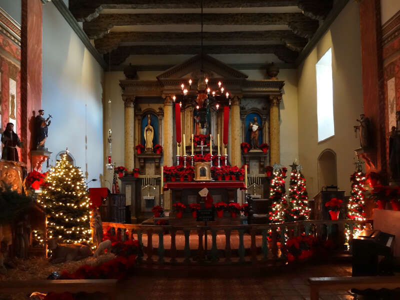 Nave and altar of Mission San Buenaventura, with Christmas decorations