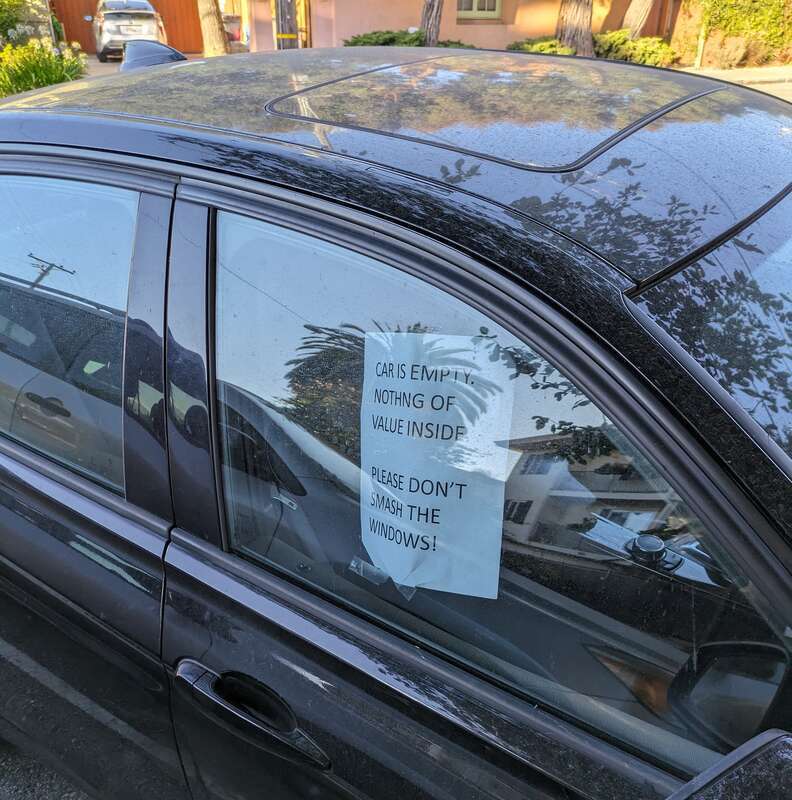 A car in Oakland, California, United States, with a sign in the window saying &quot;CAR IS EMPTY. NOTHING OF VALUE INSIDE. PLEASE DON'T SMASH THE WINDOWS!&quot;