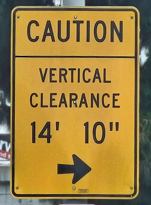Traffic sign indicating an upcoming bridge has an underside clearance of 14 feet 10 inches (4.52 m).