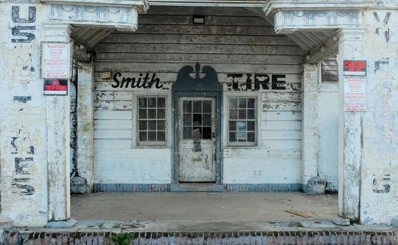 Smith Tire - No Trespassing.   Closed business on St Claude Avenue, Faubourg Marigny, New Orleans.