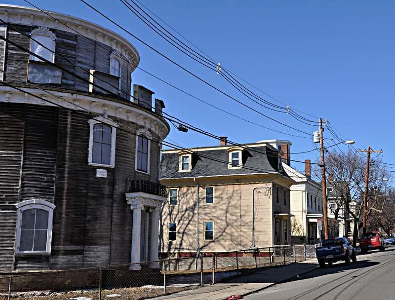 A photograph of Atherton Street, part of the Spring Hill Historic District in Somerville, Massachusetts.  Somerville's Round House is visible to the near left.