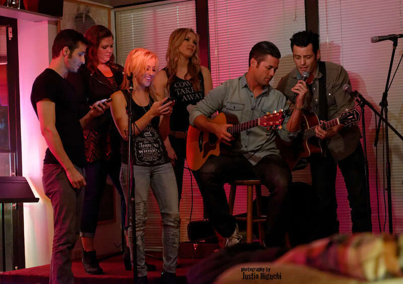 &quot;NAMM Week: Songwriter Series&quot; Songwriters Round at The Ugly Mug Cafe in Orange CA on January 22nd, 2014. Kaela Kinney (tall blonde), Ry Bradley (right), Ryan Terrigno (left), Katelyn Marie (Jack Daniels tshirt), Heidi Howard (dark hair), and Scott