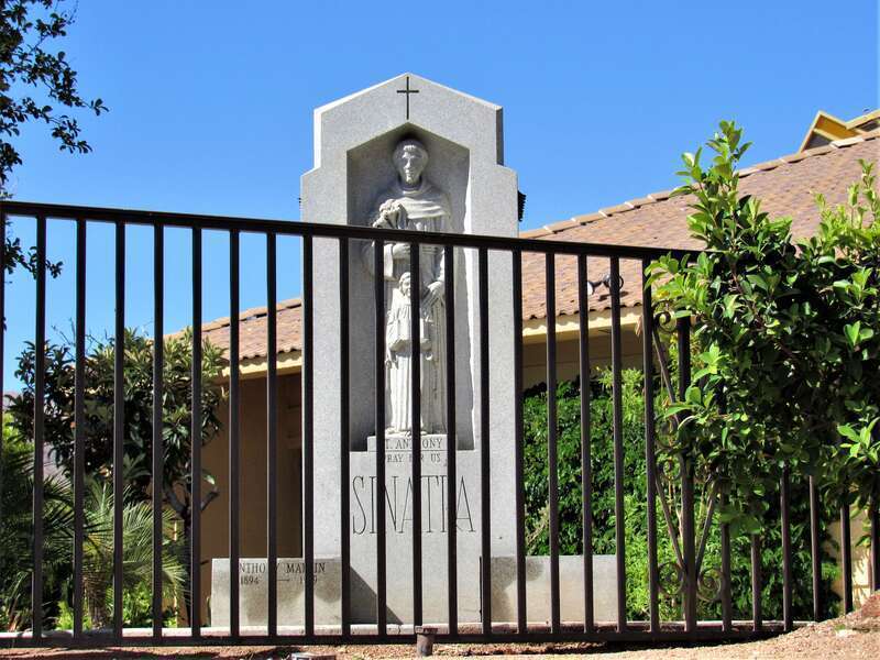 St Anthony of Padua shrine with &quot;SINATRA&quot; in large letters on the main shaft and &quot;Anthony Martin 1894-1969&quot; on the lower left. It is located behind St. Louis Catholic Church in Cathedral City, California.