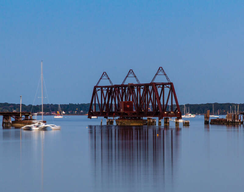 An evening image of the open Back Cove swing bridge.

The rail swing bridge and trestle was built in 1848 when the Atlantic &amp; St. Lawrence railroad began service from Portland to Yarmouth Maine. To cross the Portland peninsula, the trestle was