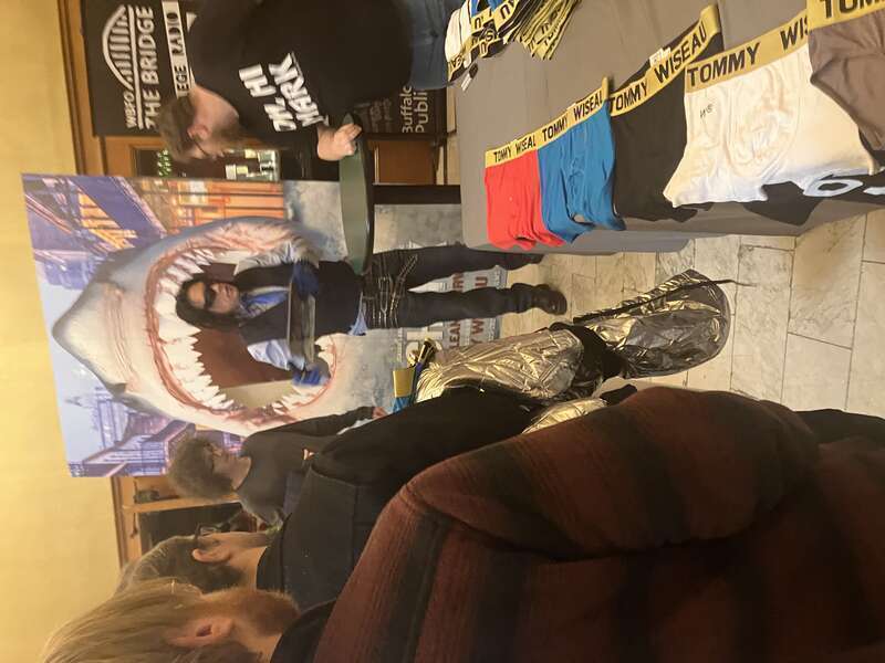 Tommy Wiseau at a signing surrounded by fans at North Park Theater in Buffalo, NY