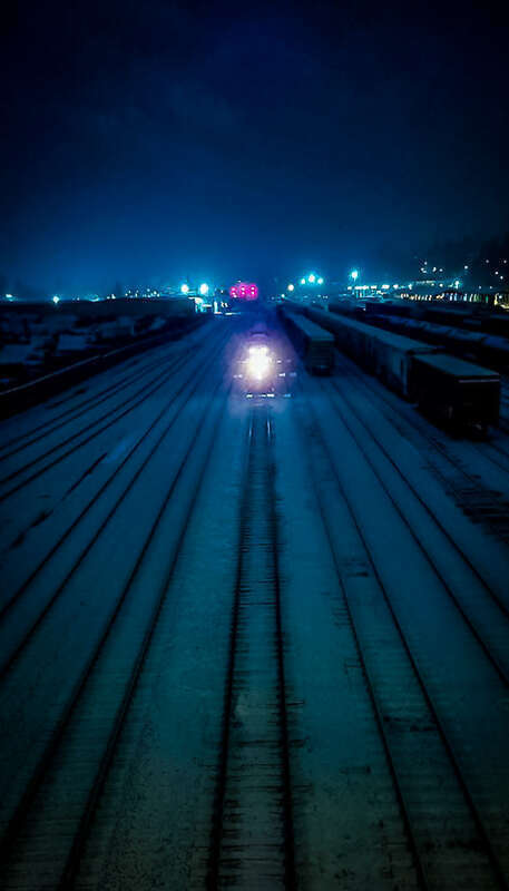 500px provided description: Train at night during a cold winter night in Vancouver Washington. [#blue ,#minimal ,#lines ,#perspective ,#Landscape ,#Snow ,#Winter ,#Night ,#Train ,#Transportation ,#City life]