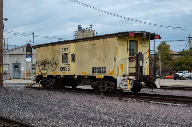 CNW 10935 caboose resting in a Union Pacific yard in Waukegan  Illinois.