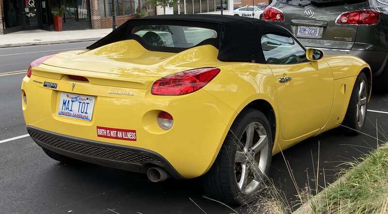 Another rear view of a yellow Pontiac Solstice