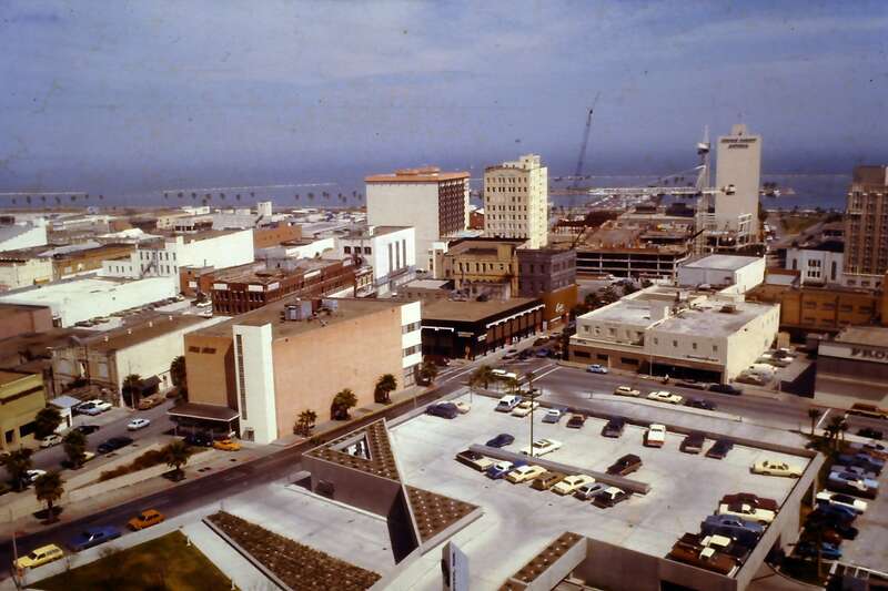 This picture was taken from the Wilson Building looking down on the parking lot on top of a Bank of America drive-through bank.  To the left of the parking lot is the old library.