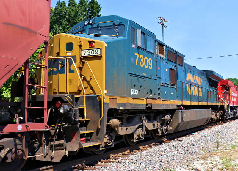Burlington Northern Santa Fe 5062(C44-9W), 8549(SD70ACe), General Electric Company 7309(C40-8W) and Canadian Pacific 8024(AC4400CWM) Leading a Westbound Covered Hopper on the Emporia Sub at the Santa Fe Street crossing west of Kansas Avenue in