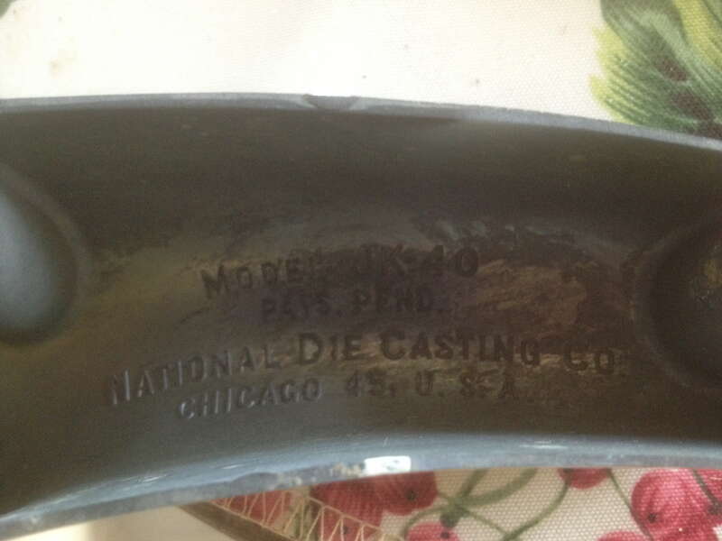 Underside of Juice King model JK-40 juicer showing model number and manufacturer information &quot;Model JK-40 PATS. PEND. National Die Casting Co. Chicago 45, U. S. A.