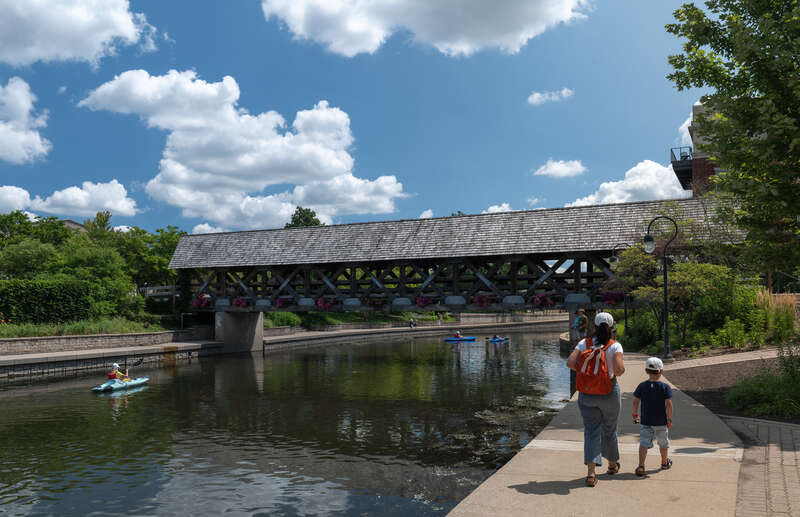 Jules and Gabriel at the riverwalk near a covered bridge, Naperville, Illinois, US