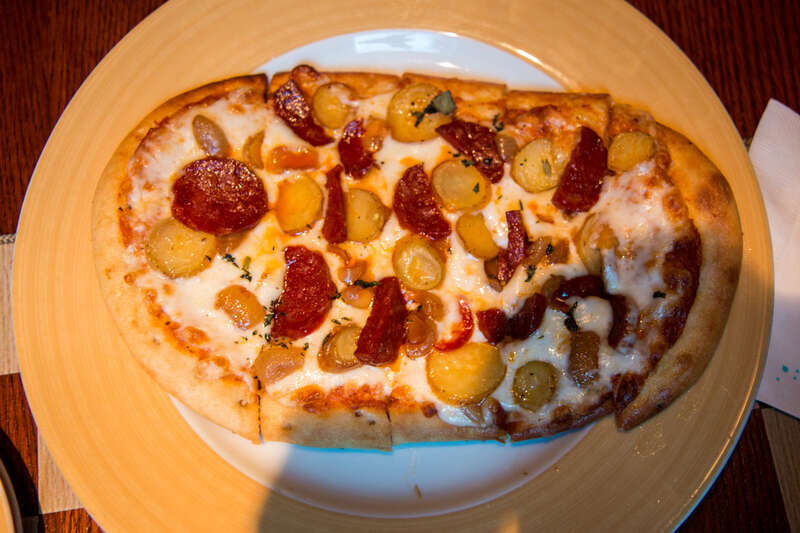 At the Hearthstone Lounge: Robusto Flatbread topped with Chorizo de Bilbao, Roasted Fingerling Potatoes, Mozzarella Cheese, and Romesco Sauce.