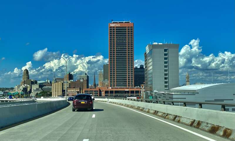 Seen on a sunny afternoon in September 2021 is the view of the downtown Buffalo skyline that's enjoyed by drivers arriving in the city from the southern suburbs via the Skyway (NY 5 eastbound). At center is Seneca One Tower; in the foreground to the