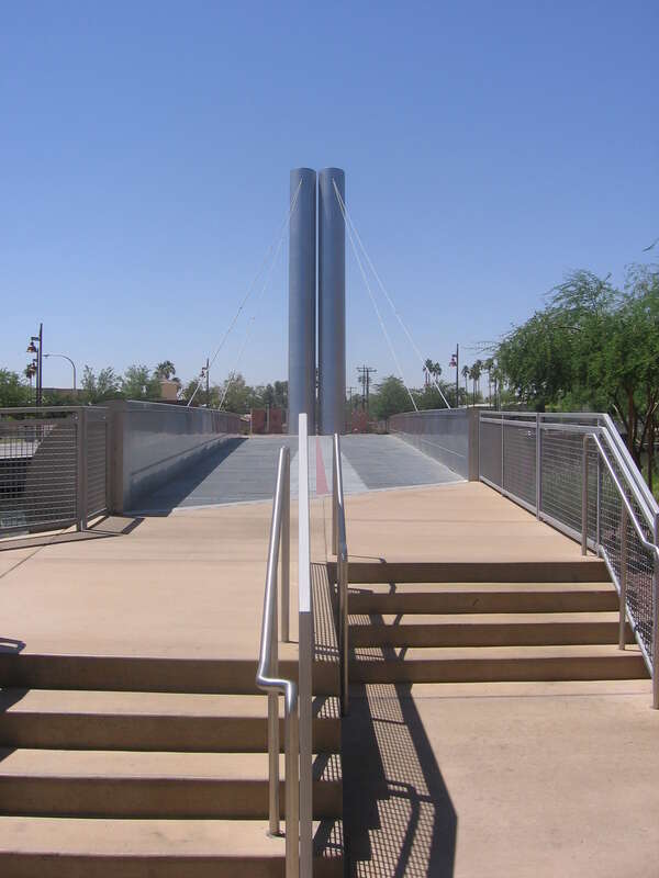 Pedestrian bridge over the Arizona Canal in Scottsdale, Arizona, USA near the intersection of North Scottsdale Road and East Camelback Road.  The bridge was designed by architect Paolo Soleri.  This view is looking south.