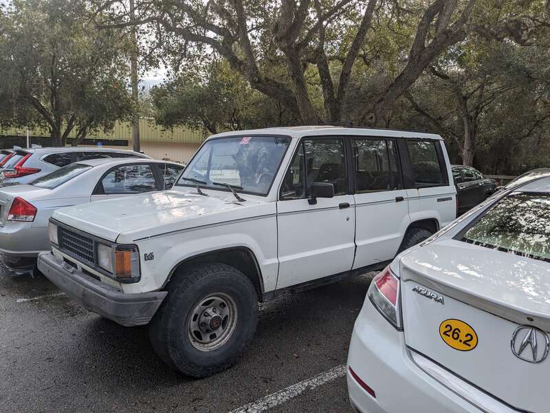 A white 1991 Isuzu Trooper parked at the Palm Bay Public Library, Palm Bay, Florida