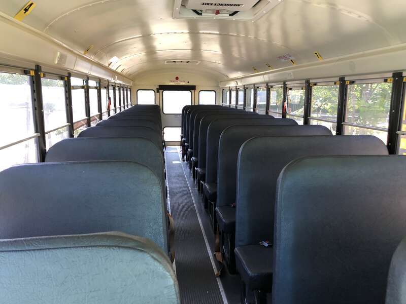 Rear-facing interior view from the front of a First Student school bus at a bus depot in East Orange, Essex County, New Jersey