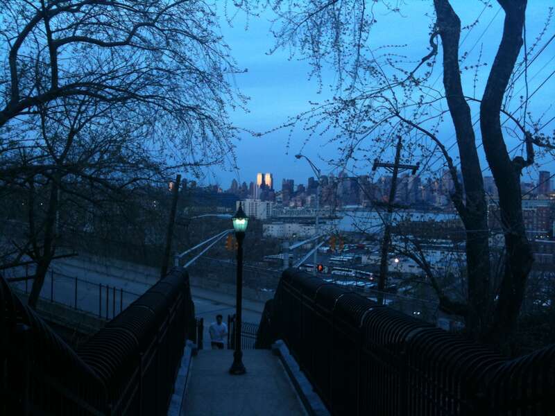 A shot of Manhattan's Upper West side, showing Time Warner Center catching the last rays of sunlight at sunset (background), taken from Union City, New Jersey (foreground), showing Hoboken in the middle.