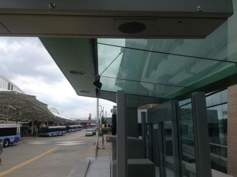 Regular buses and platforms seen to the left, station building to the right.