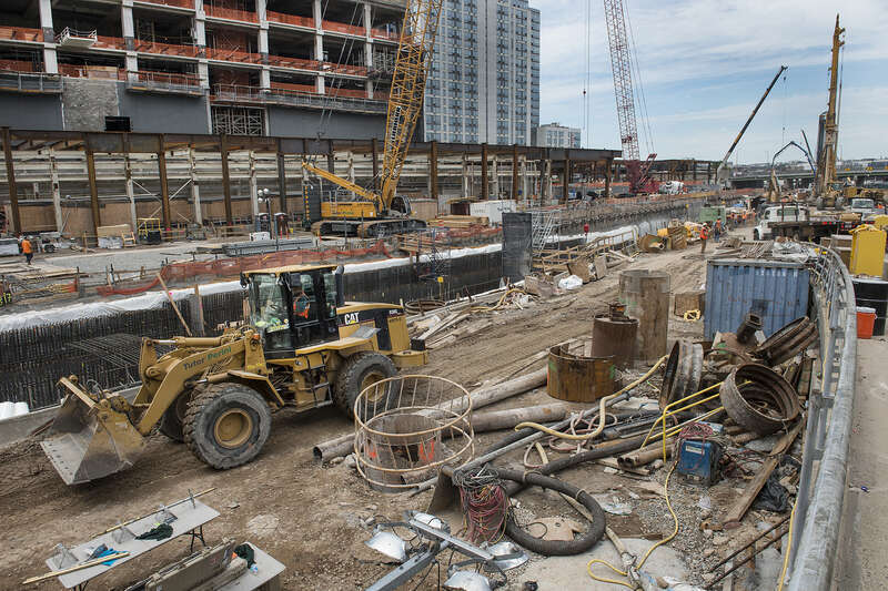 Giant cranes and boring machines work in tight quarters with the Long Island Rail Road’s 24/7 operations at the LIRR west side storage yard to construct the platform that will support the office towers, apartments and shopping center of a new