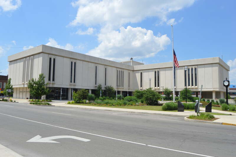 Southern and eastern sides of the Delaware County Courthouse, located in the block surrounded by High, Main (State Road 32), Walnut, and Washington Streets in Muncie, Indiana, United States.  It was built in 1969 to replace a historic courthouse that
