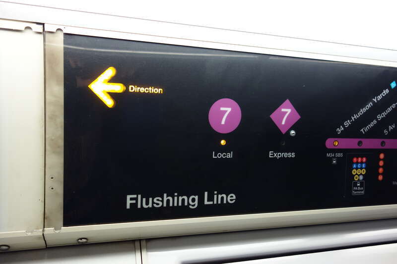 The interior of an R188 train in 7 service, taken on the IRT Flushing / 42nd Street line between Times Square and 34th Street – Hudson Yards in Midtown Manhattan. Pictured is the strip map, with a selector for 7 Local or &amp;lt;7&amp;gt; Express.