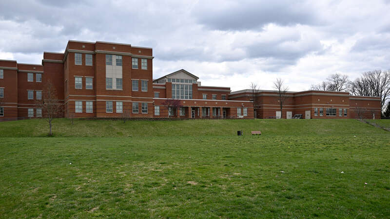 The rear of Lakelands Park Middle School with grassy field, part of the Montgomery County Public Schools system. 1200 Main Street, Gaithersburg, Maryland 20878.